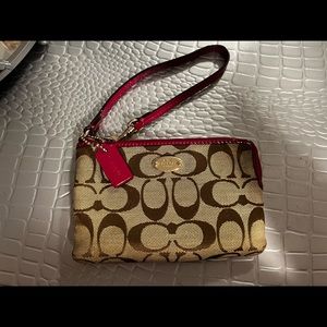 Coach monogram wristlet with pink details